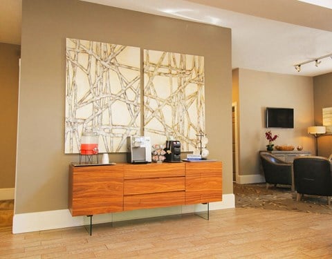 a living room with a dresser and a television in a hotel room